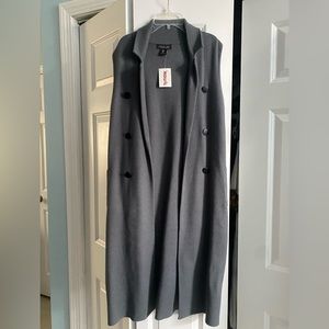No sleeve long pea coat.  With pockets. Perfect for the fall or spring to layer!